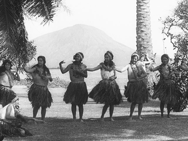 Hula dancers performing at a beach.